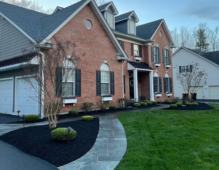 excellent landscaping and hardscaping of grass, stones and trees by NP Landscaping