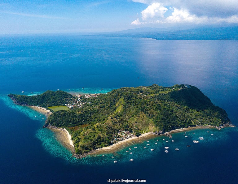 a small island with a small island in the middle of the ocean