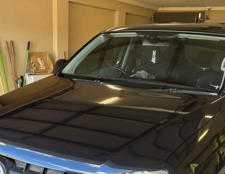 Close-up of a dark blue 4x4 parked in a garage after ceramic paint protection applied
