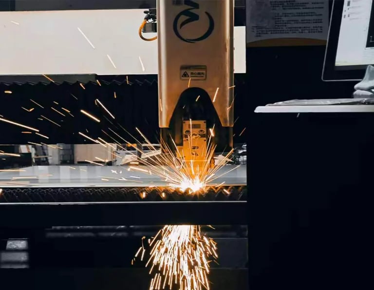 Precision CNC fiber laser cutting machine sparks while processing a metal sheet in an industrial factory.