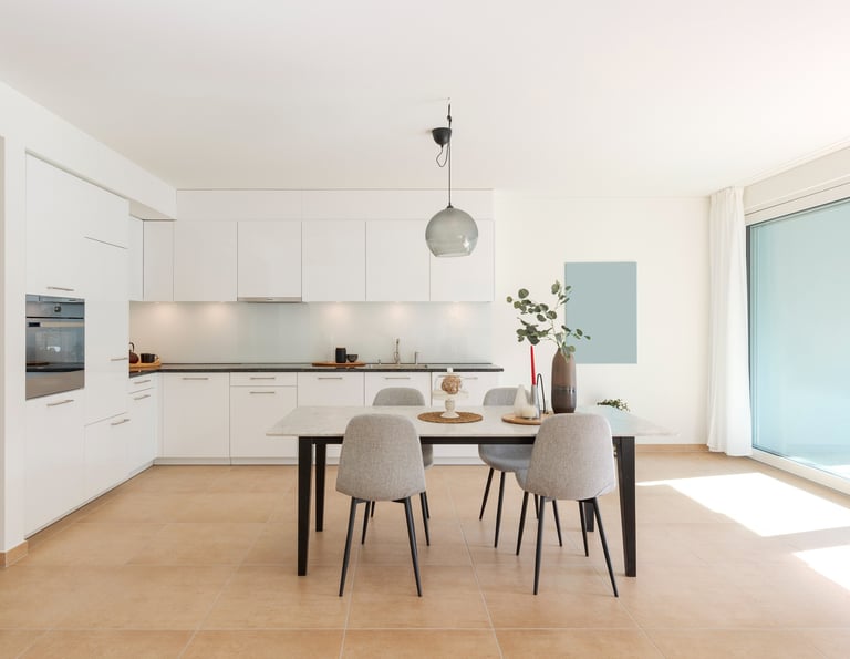 a dining room with a table and chairs