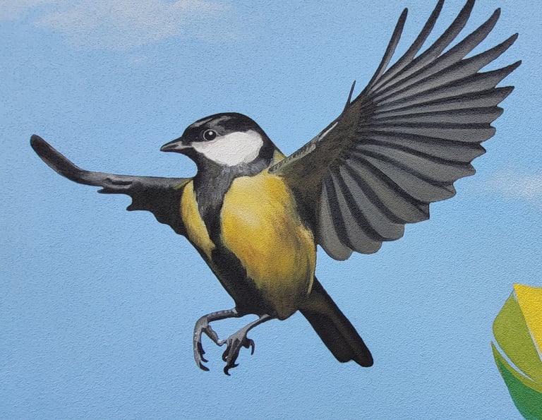 Détail de la peinture d'une fresque murale: une mésange prend son envol. Viry, Jura, 39.