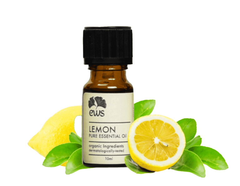 Fresh yellow cut lemon next to Lemon Essential Oil Bottle