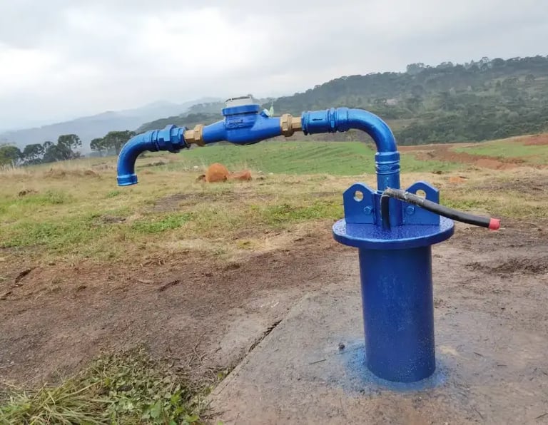 a blue water pump with a blue pipe on top of it