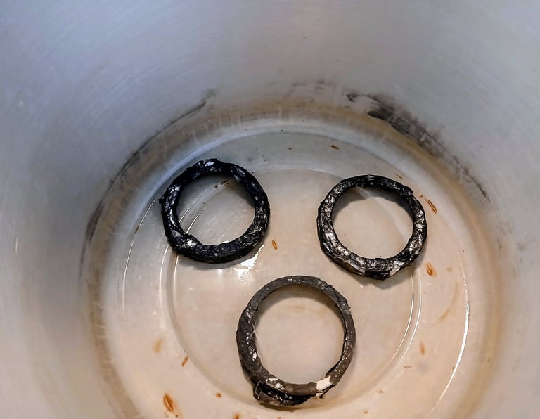 metal jar lids sitting in a pressure cooker to lift the rack off the bottom