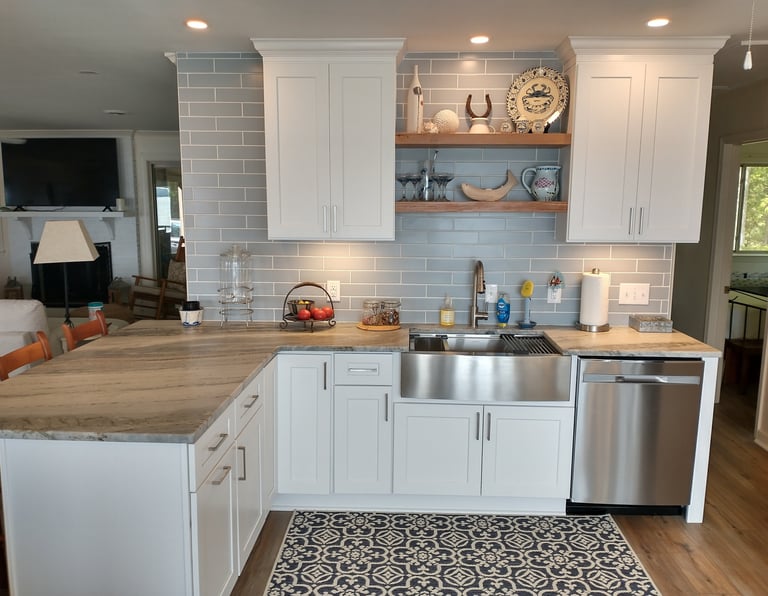 white cabinets with quartzite countertop and blue subway tile