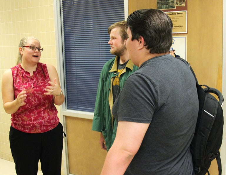 Dr. Hooton, left, discussing Mexican American history with two students (right) at Angelo State.