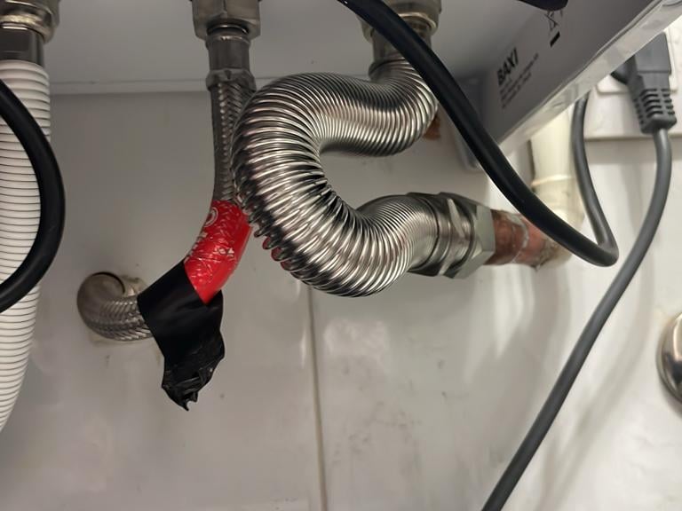a bunch of pipes and pipes in a bathroom