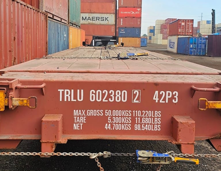 Red 40ft Flat Rack showing 98,540 Lbs. weight capacity