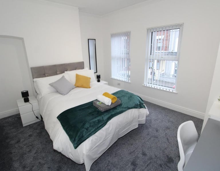 bedroom with bed and white walls