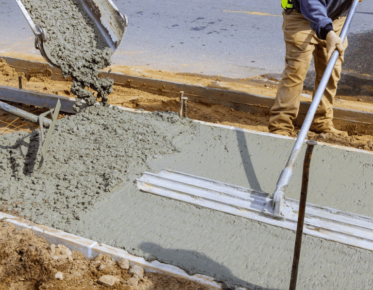 a man is pouring concrete into a concrete slab