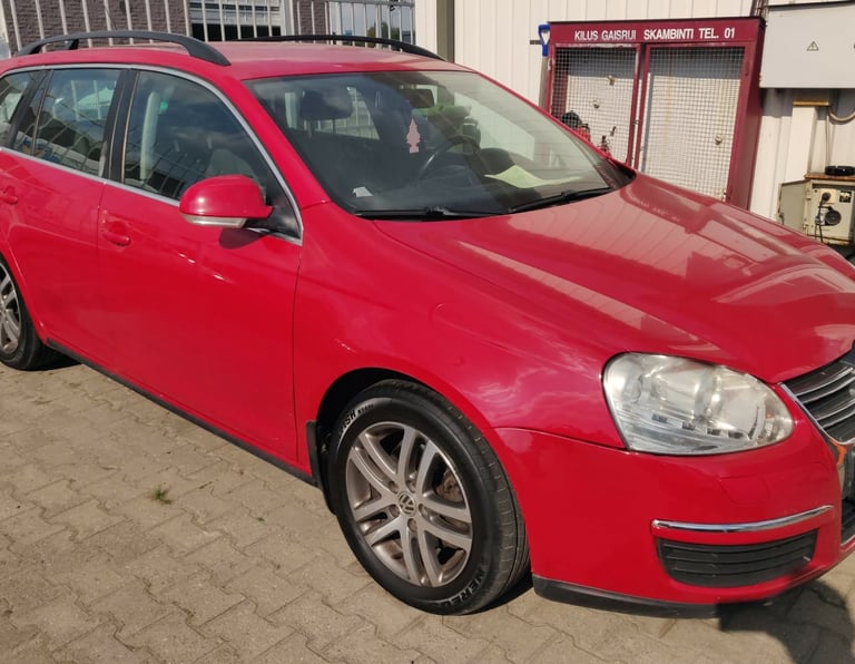 a red car parked in front of a building