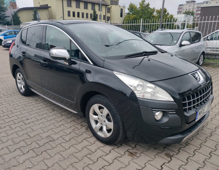 a black car parked in a parking lot