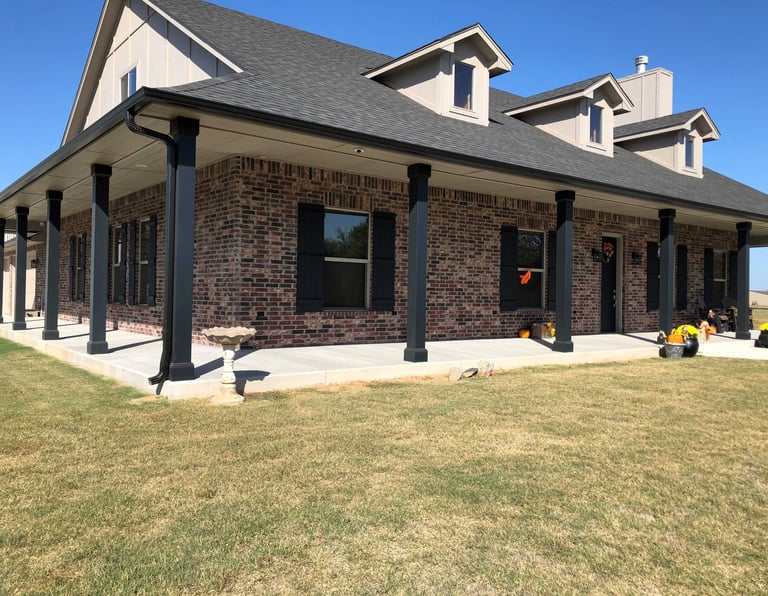 outside of new house with porch and lawn