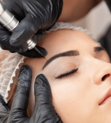 a woman getting her eyebrows done by a professional hairdresser