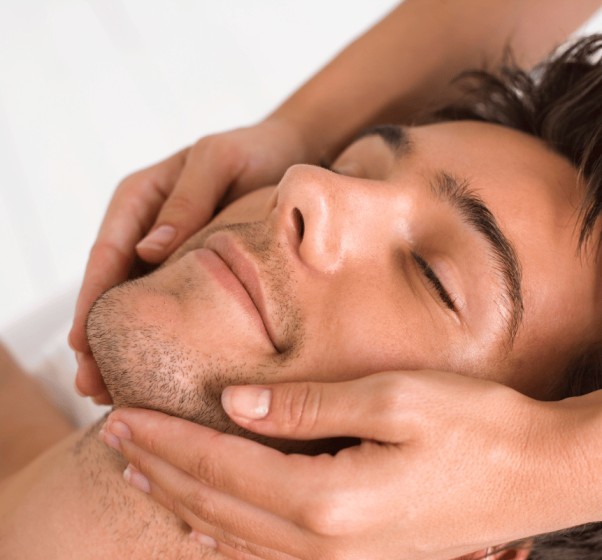 a man getting a massage and skin-care at a spa