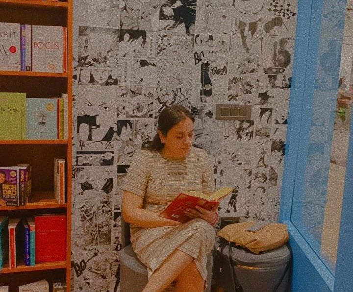 A woman reading in a bookstore