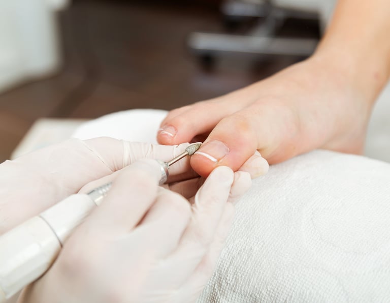 a person is getting their nails done by a pedicuring