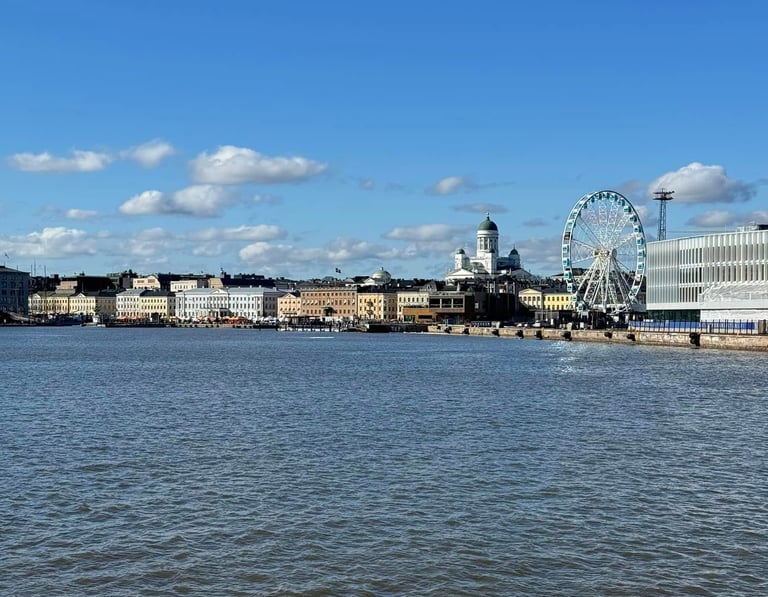 a view of the harbor with a ferris wheel and cathedral in the background