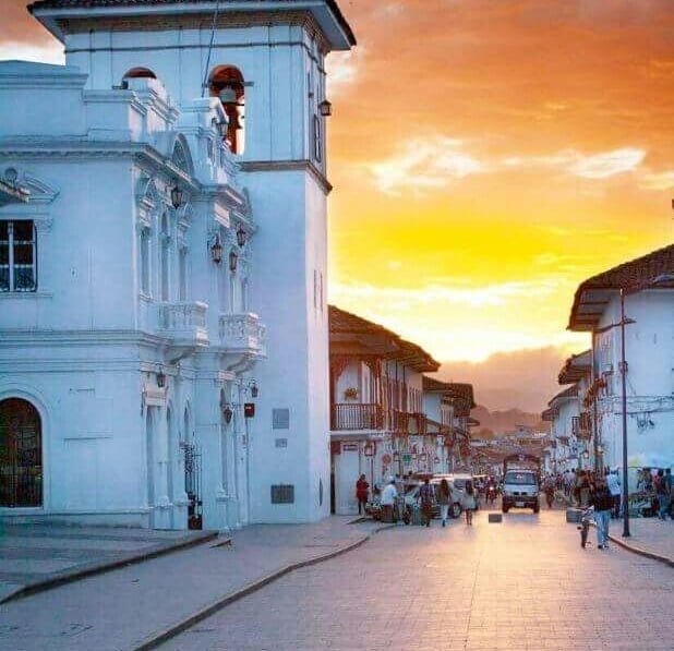 Sunset over white colonial architecture and cobblestone streets in Popayán, Colombia.