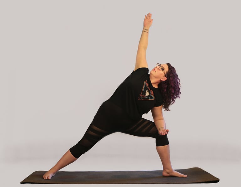 rachel in yoga pose, black outfit purple hair white background