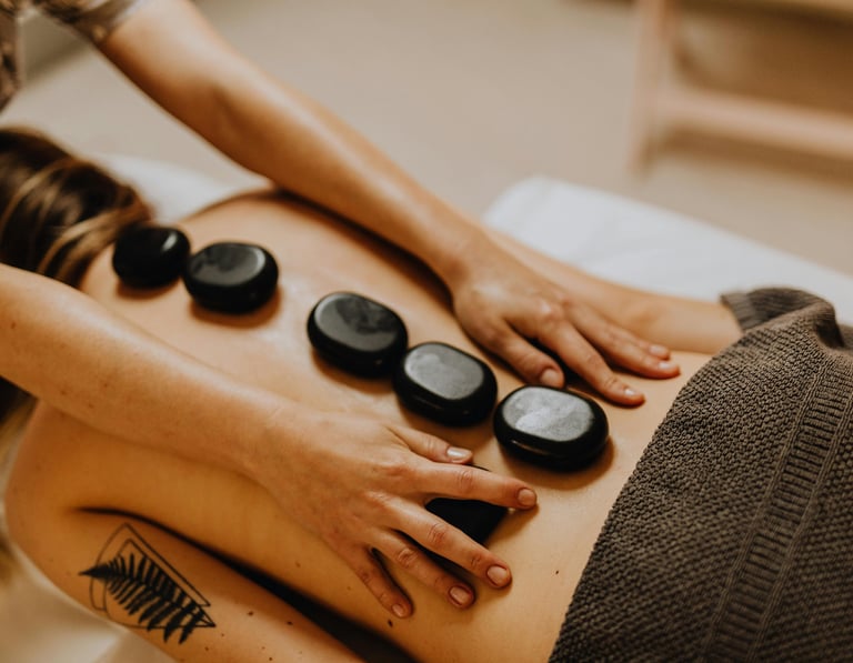 Hot stone massage treatment for guests (photo courtesy of pexels)
