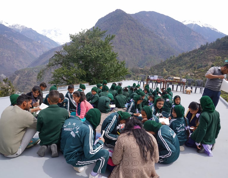 People sitting on the ground amidst mountains