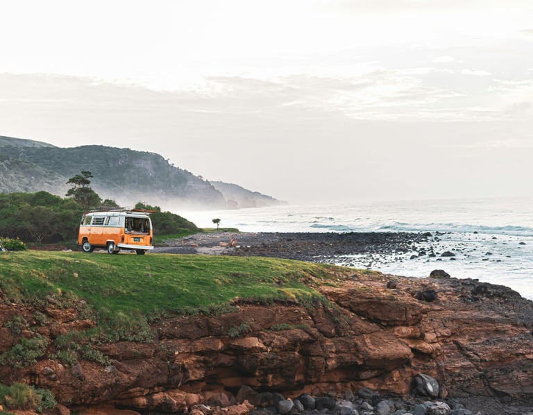 unrise over a campervan parked on a scenic cliffside, ready for a day of exploration
