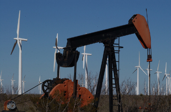 Pumpjack and Wind Turbines in a field