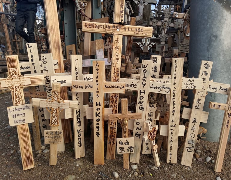 Handmade wooden crosses with Liberate Hong Kong messages at the Hill of Crosses pilgrimage site.