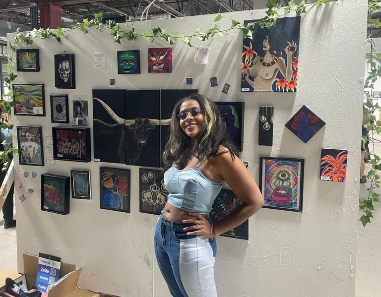 Alexis Peralta the artist standing in front of her wall of art at a gallery tacosxart
