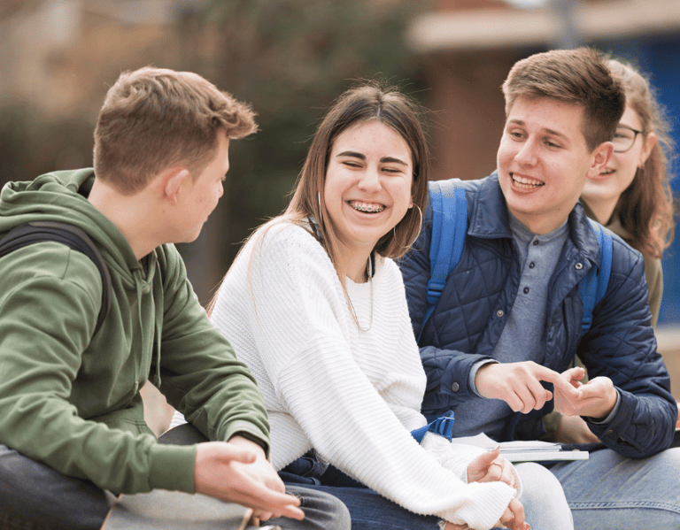 a group of young people sitting on a bench