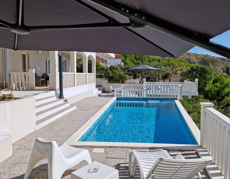 View from the west sun terrace of the pool, apartment balcony and the east sun terrace.