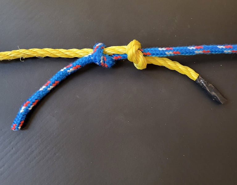 A fisherman's knot before final tightening, showing the two opposing overhand knots structure.