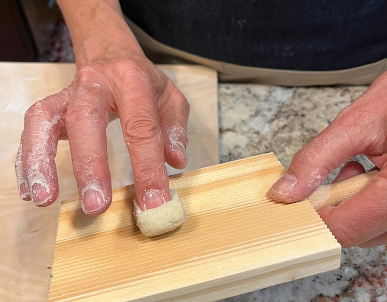 Forming gnocchi on wooden board