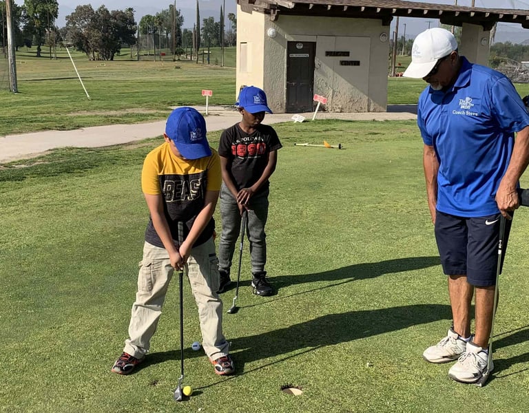 Enhancing Forward Action image of golf instructor teaching young students how to put
