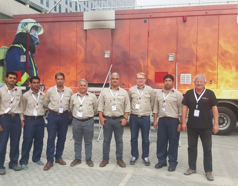 Premiers For Equipment Managers & Staff Standing in Front of MTU (Mobile Training Unit)