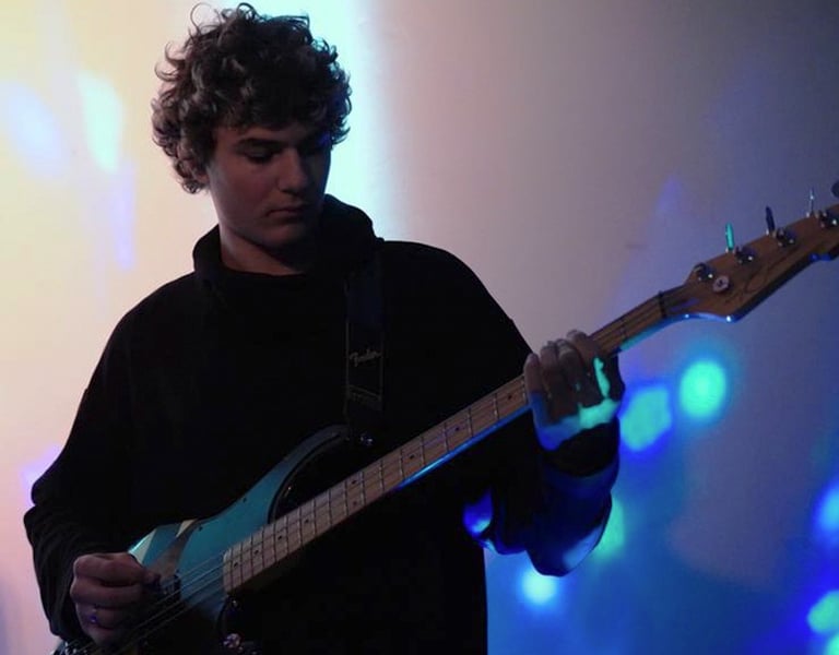 a man playing a guitar on stage