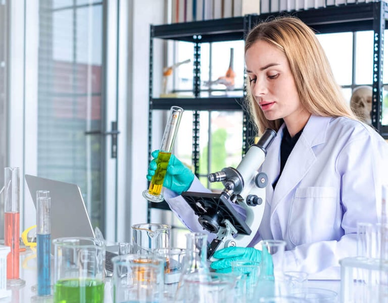 Profissional mulher biomédica fazendo análises de amostras clínicas.