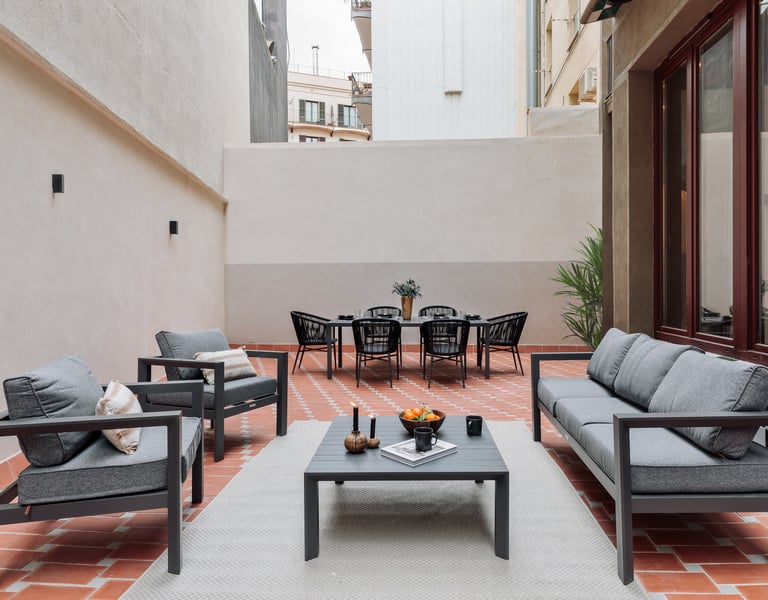 Private terrace with seating, dining area and plants, designed by SAVIA