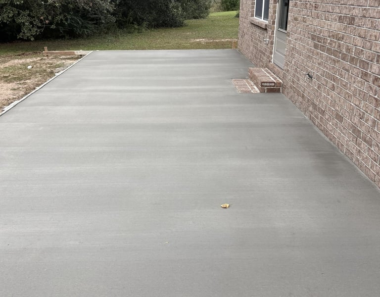 Side yard concrete walkway installation in Navarre FL with smooth surface