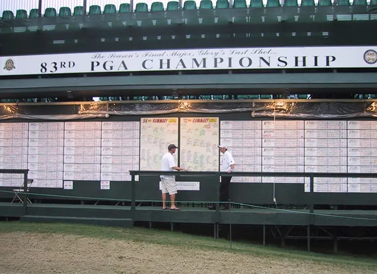 Casey standing in front of his scoreboard at the 83rd PGA Championship.