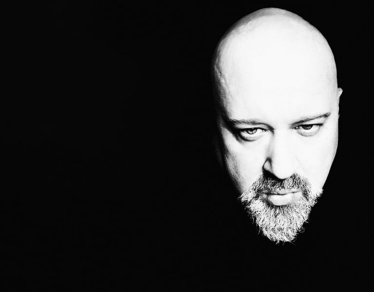 Dramatic black and white high-contrast portrait of Sébastien Lovat