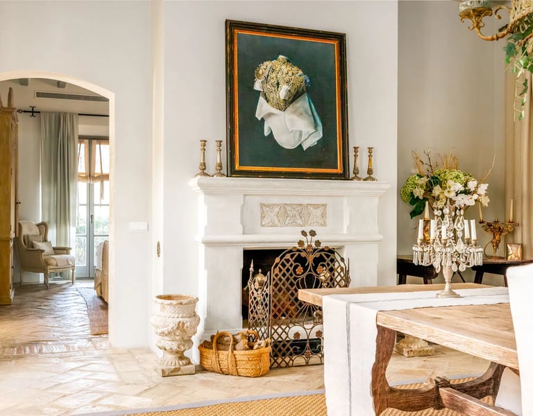 Fireplace with artwork and rustic decor at Finca Santa Katerina
