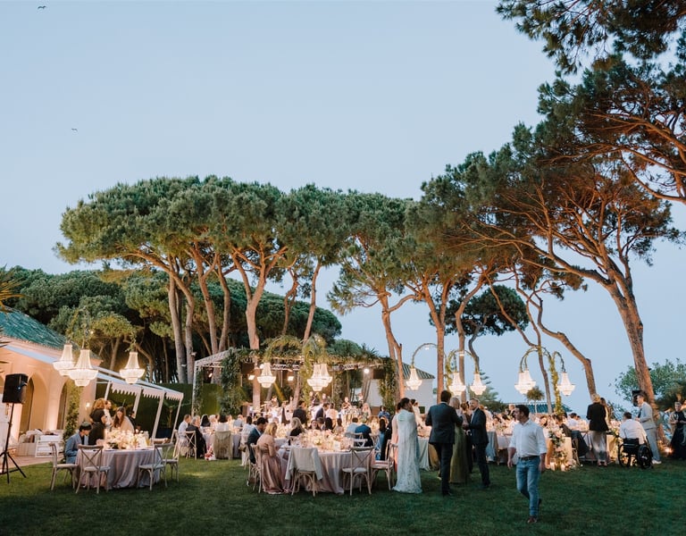 Evening wedding reception at Villa El Rincon with chandeliers and garden dining