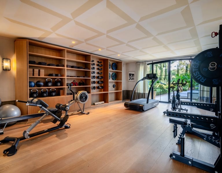 Private gym at Villa La Gratitud with modern equipment and garden views