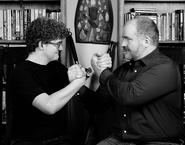 a father and a son are holding hands tight looking at each other in a library