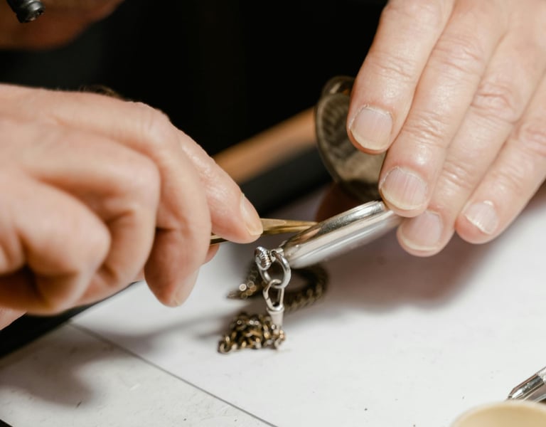 a man wearing magnifying glasses working on repairing a watch