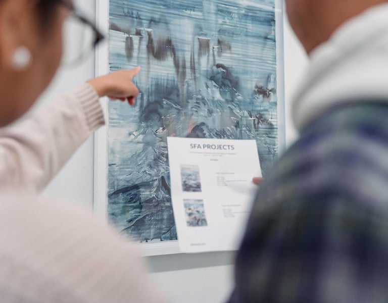 Business team at a gallery reviewing art installation plans.