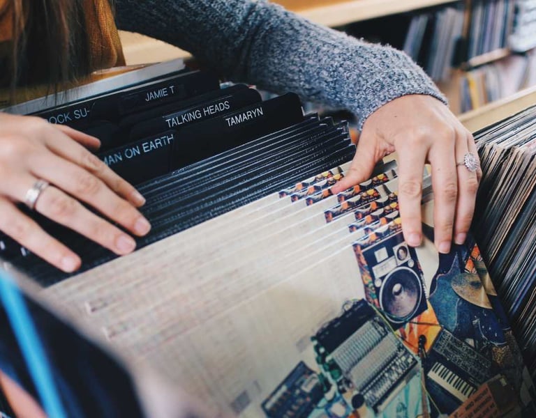 Person browsing through vinyl records